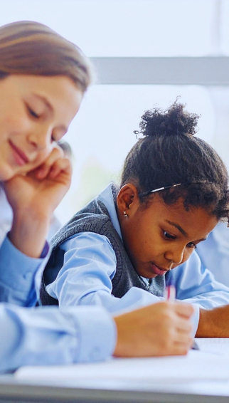 Child working through SEAG practice questions at home